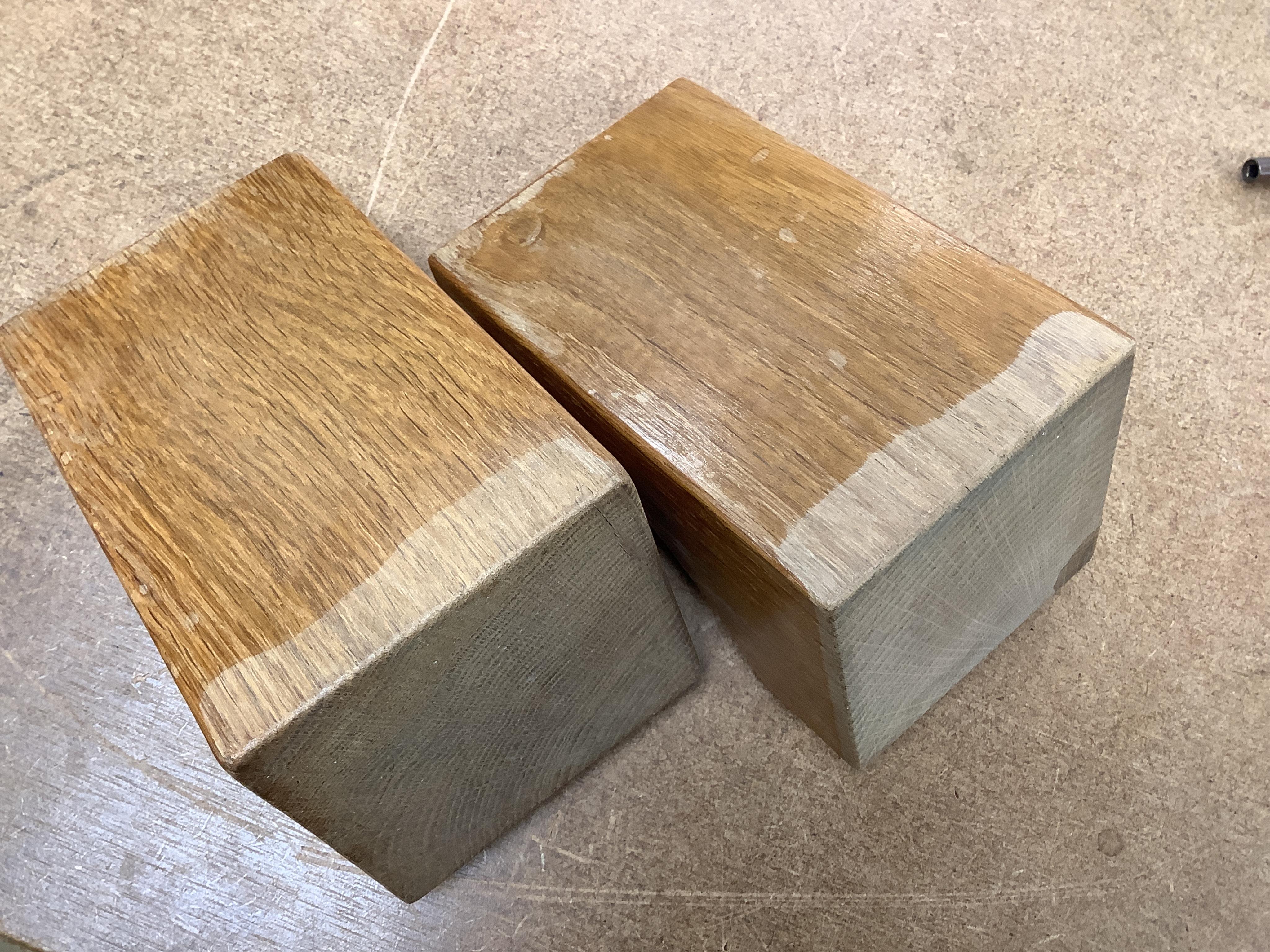 Workshop of Robert ‘’Mouseman’’ Thompson of Kilburn - a pair of English oak single mouse bookends, each with carved mouse trademark, 15cm high. Condition - good.